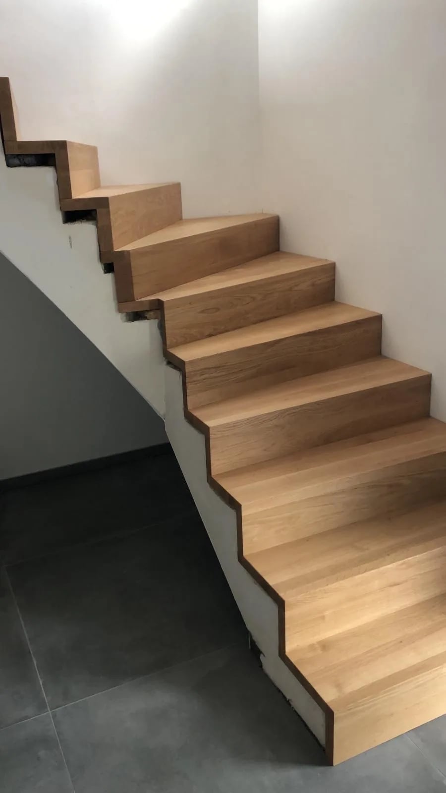 Concrete shell staircase with solid oak cladding — manufactured in our Witten workshop